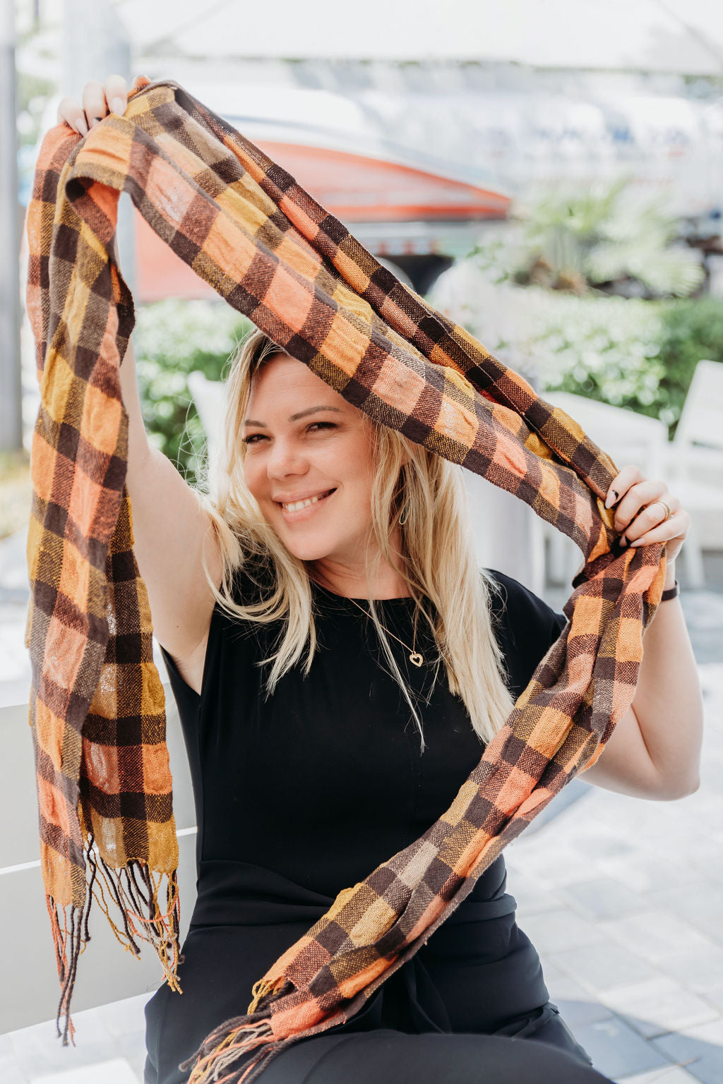 Brown merino wool and up-cycled viscose yarns being help by a model