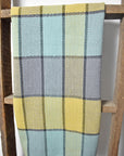 Colorful beach inspired towel hanging on wooden ladder