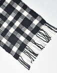 Close-up of the hand twisted fringe on the black + white handwoven wool scarf