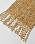 Close-up of the eyelash fringe on the golden textured handwoven scarf