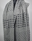 A complete view of the women's handwoven gray shawl.