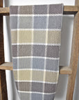 Neutral handwoven organic cotton dish towel hanging on a wooden ladder