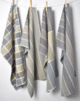 Neutral handwoven organic cotton dish towels hanging on a rope with clothespins