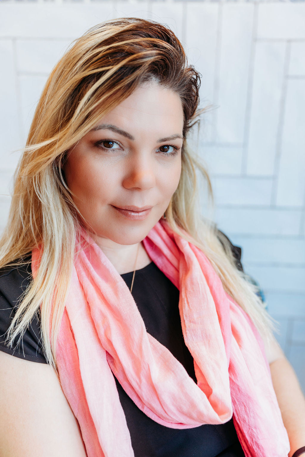 Hand-painted pink scarf draped on a model.