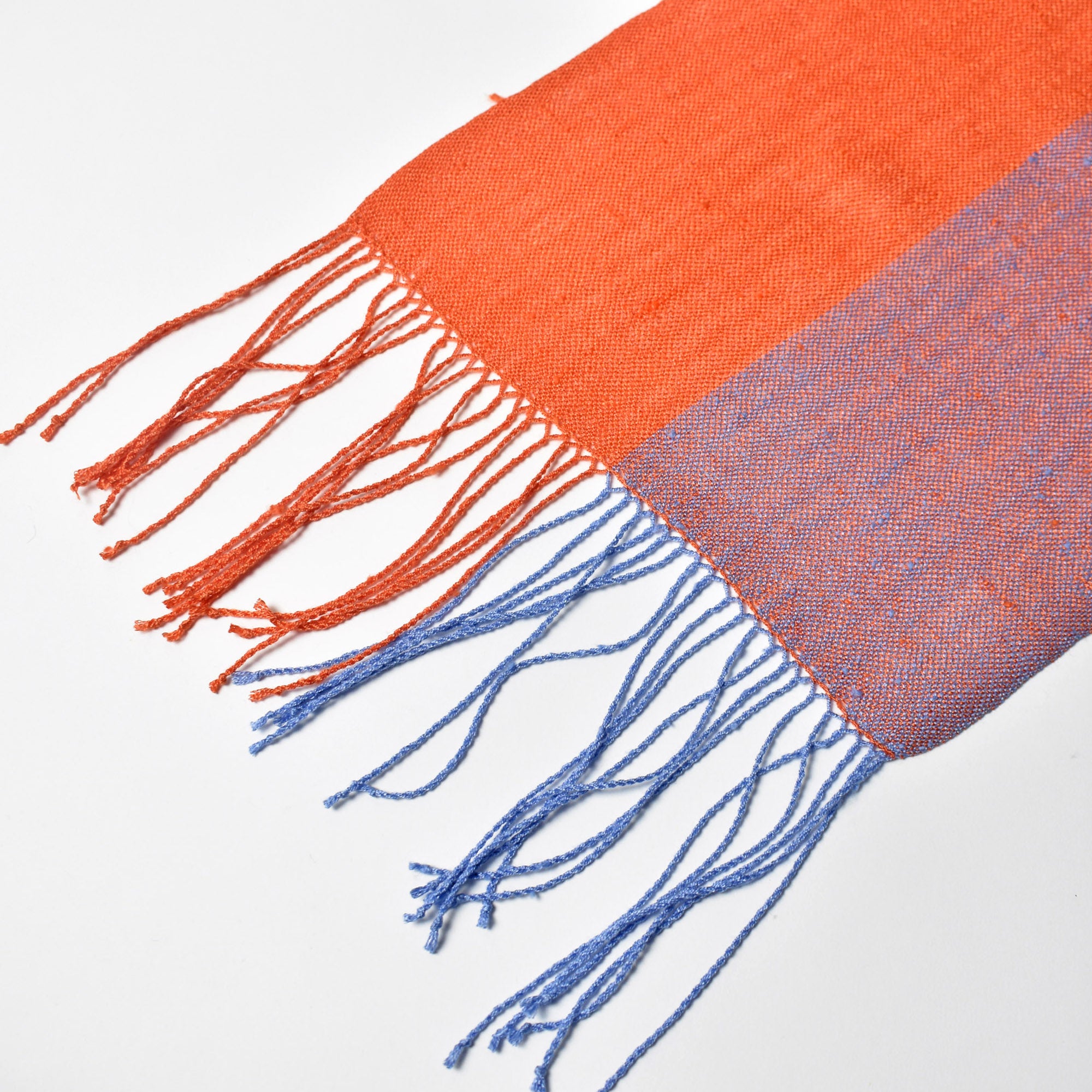 Close-up of the twisted fringe on this apricot + blue scarf