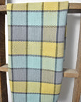 Beach inspired plaid towel hanging on a wooden ladder