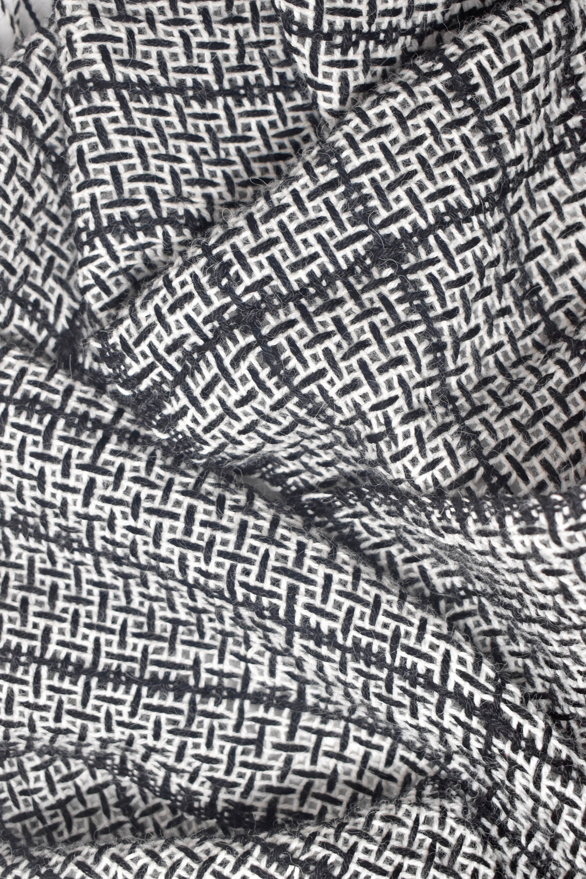 Close-up of the texture and pattern of the black+ white handwoven alpaca scarf