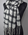 Black + white plaid merino wool scarf draped on a mannequin