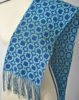 Scarf draped over a mannequin. Check out the different patterns on the front and back of the scarf