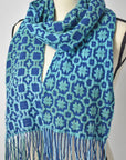 Blue + green hand painted and handwoven textured scarf on a mannequin.