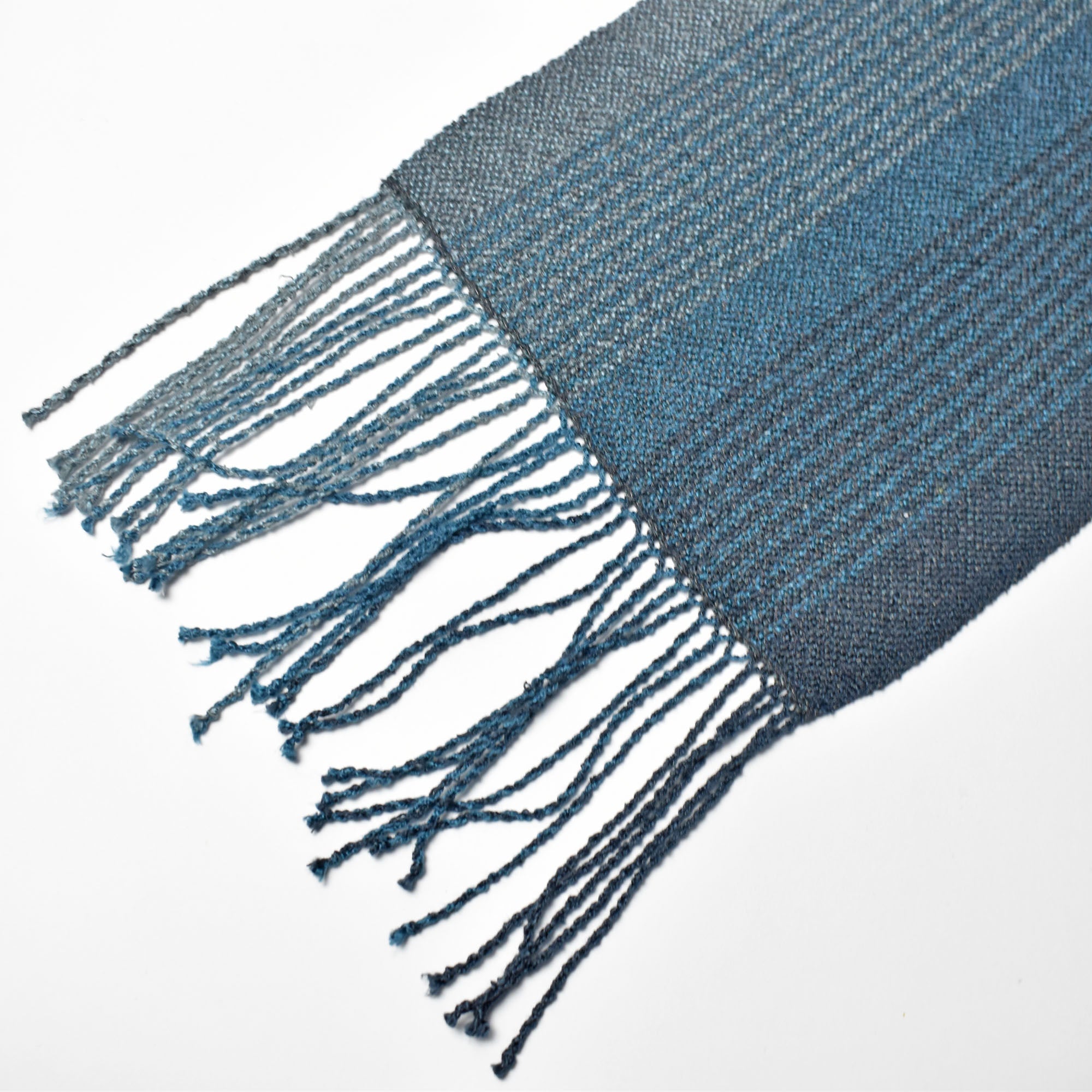 Close-up of the hand twisted fringes for the blue + green scarf