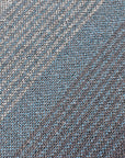 Close- up of the handwoven fabric for the blue + green scarf