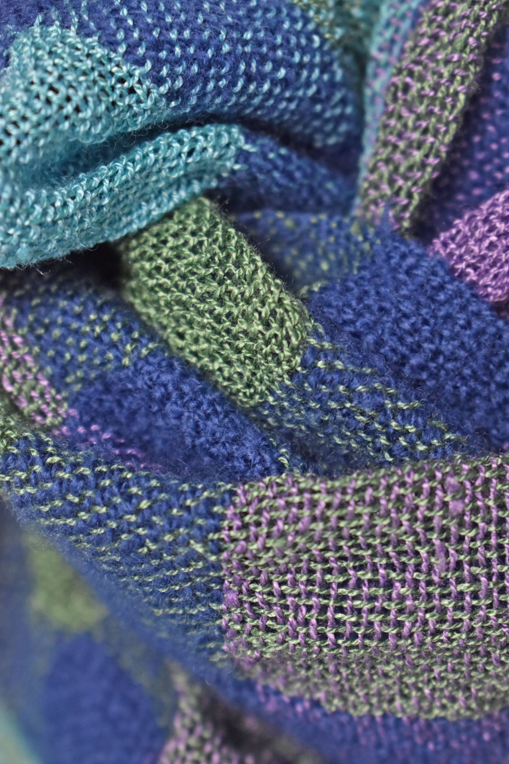 Close up of the merino wool and up-cycled viscose scarf showing the colors and texture.