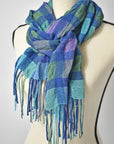 Blue merino wool and up-cycled yarns handwoven scarf with a puckered texture styled on a mannequin