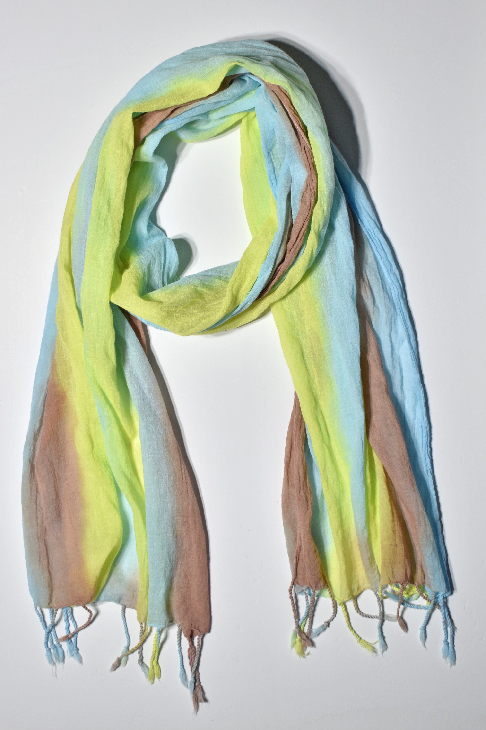 Bold colors hand-painted scarf styled on a white table