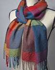 Bright colored handwoven merino wool scarf on a mannequin