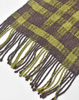 Close-up the hand twisted fringe on the brown + green handwoven scarf