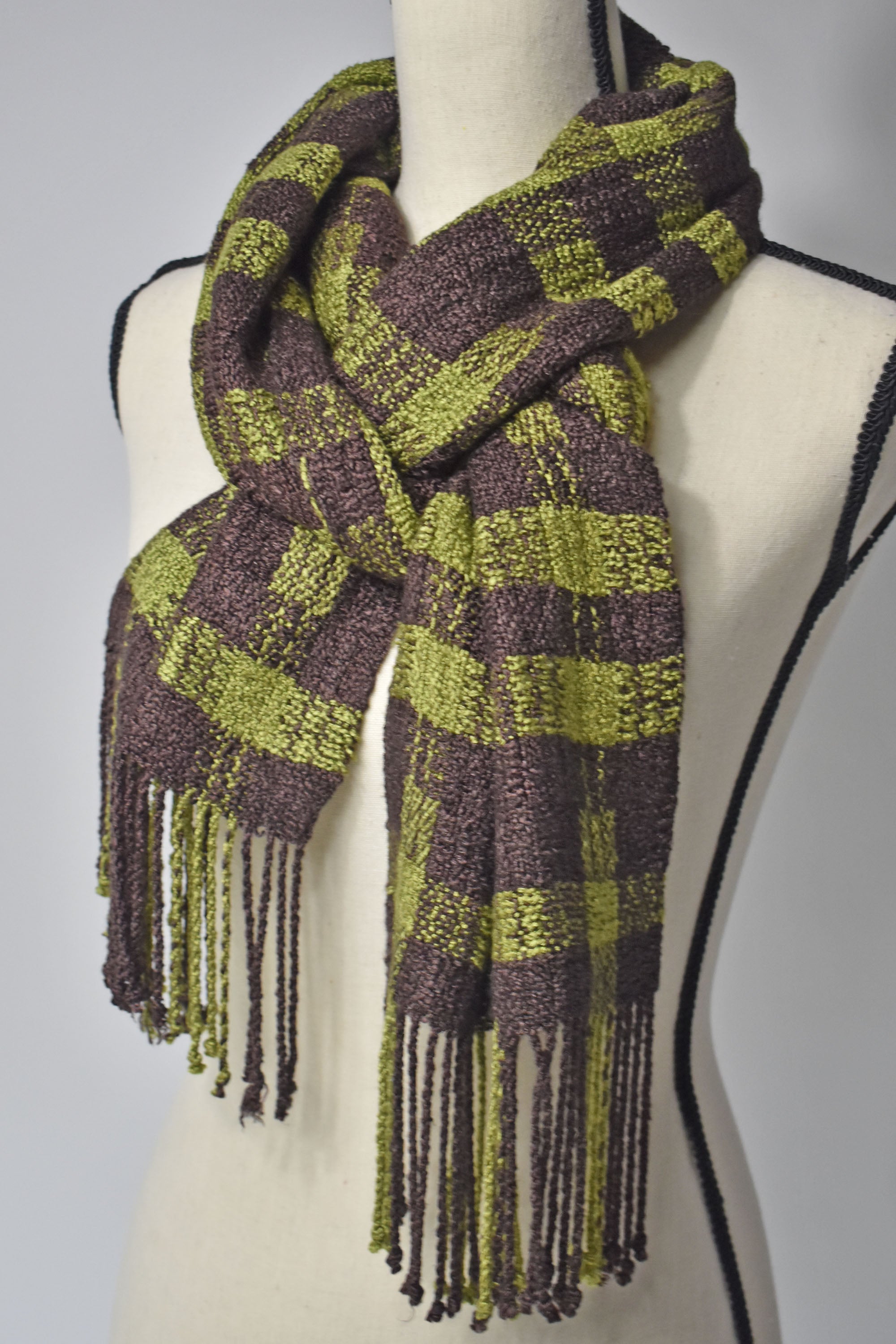 Brown + Green handwoven scarf styled on a mannequin