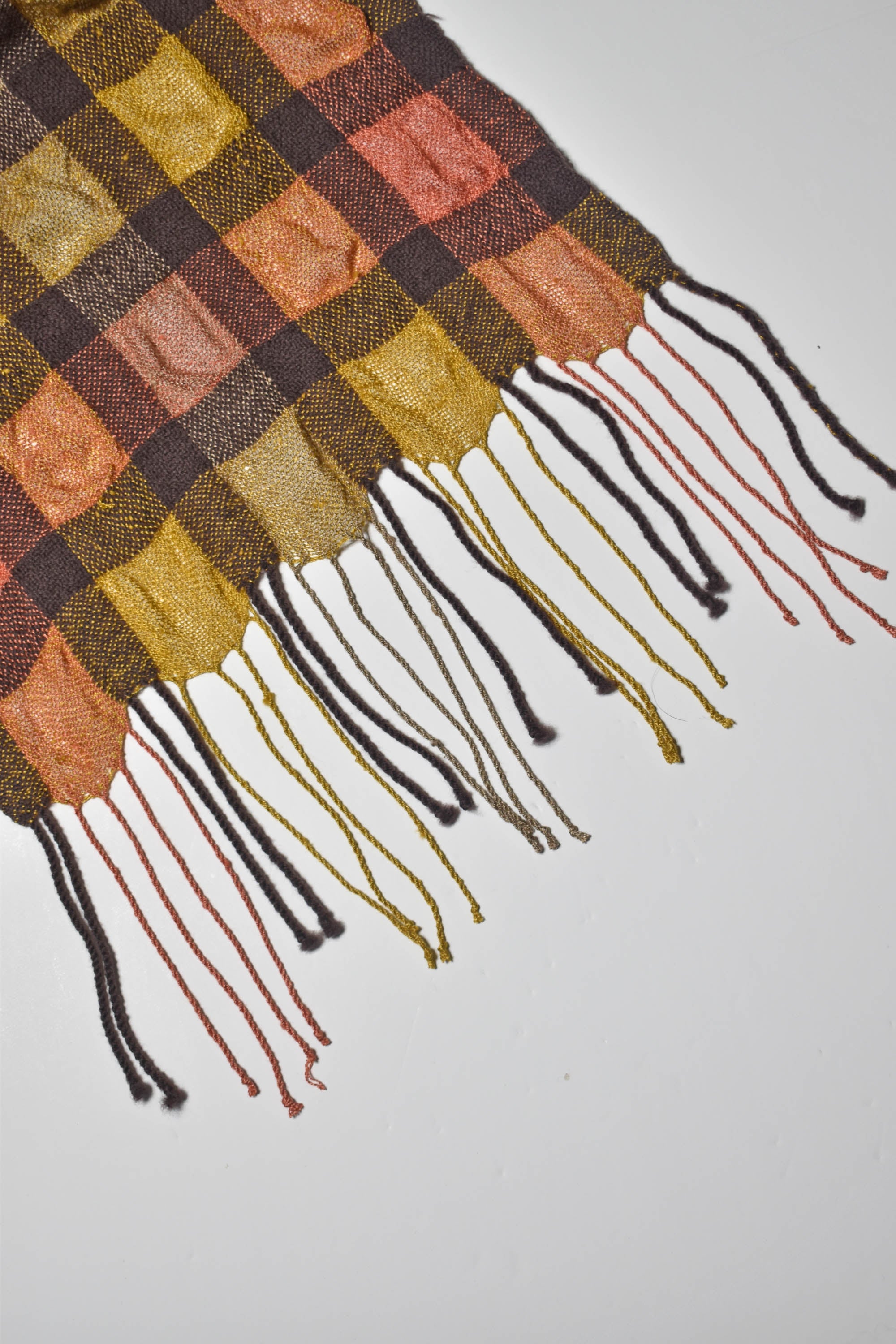 Close-up of the hand twisted fringe on this handwoven puckered scarf