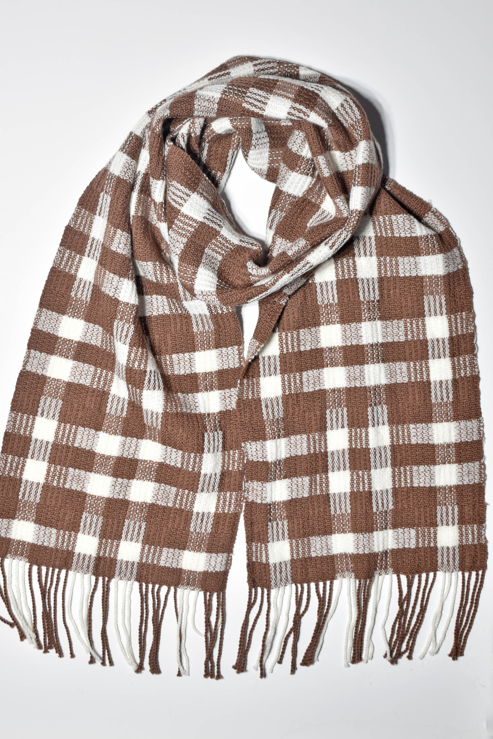 Chestnut brown + white handwoven scarf styled on a white table