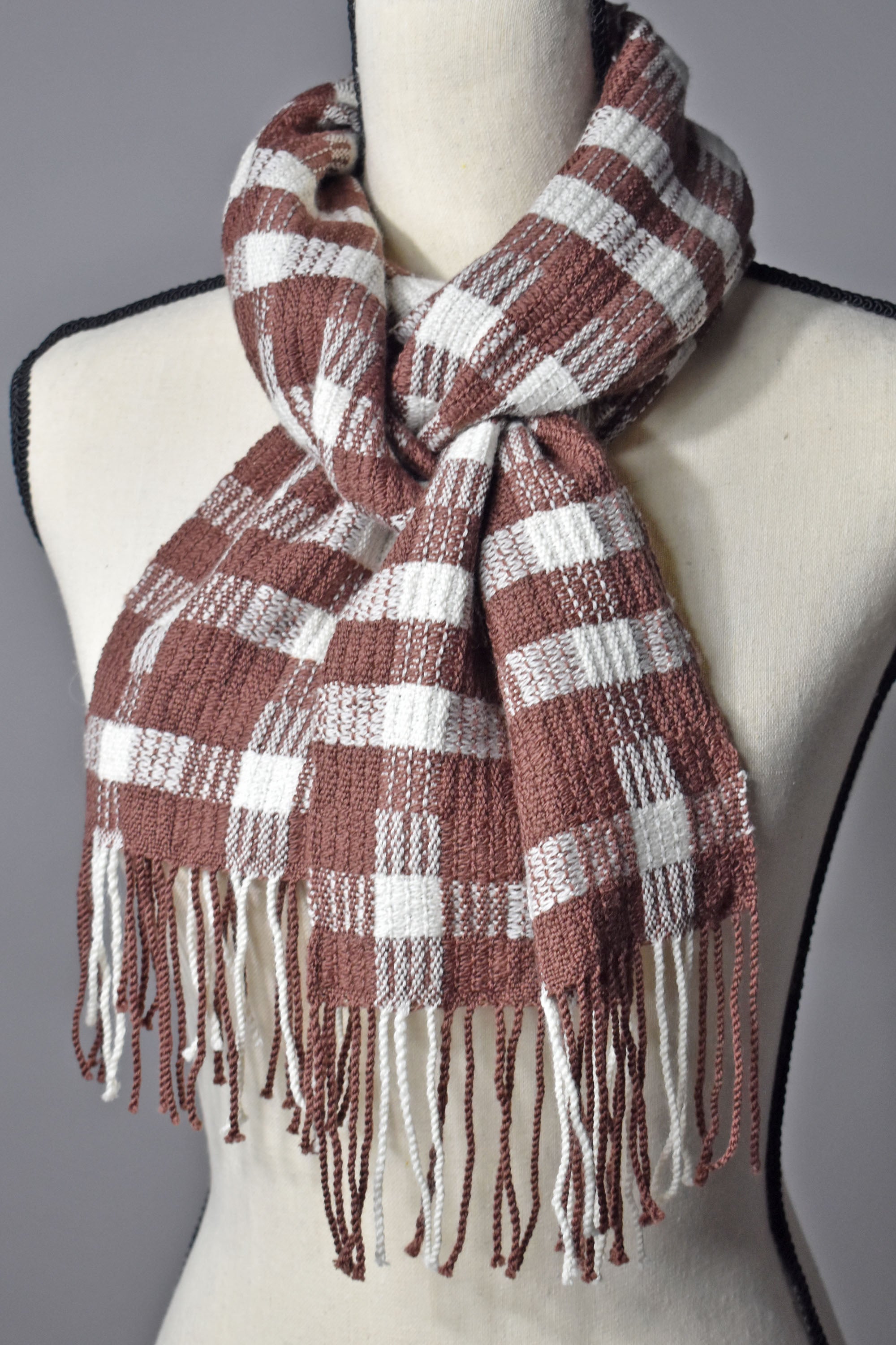 Chestnut brown + white handwoven merino wool scarf on a mannequin