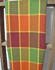 Plaid handwoven towel in a plaid design hanging on a ladder