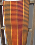 On a wooden ladder, is a handwoven cotton towel