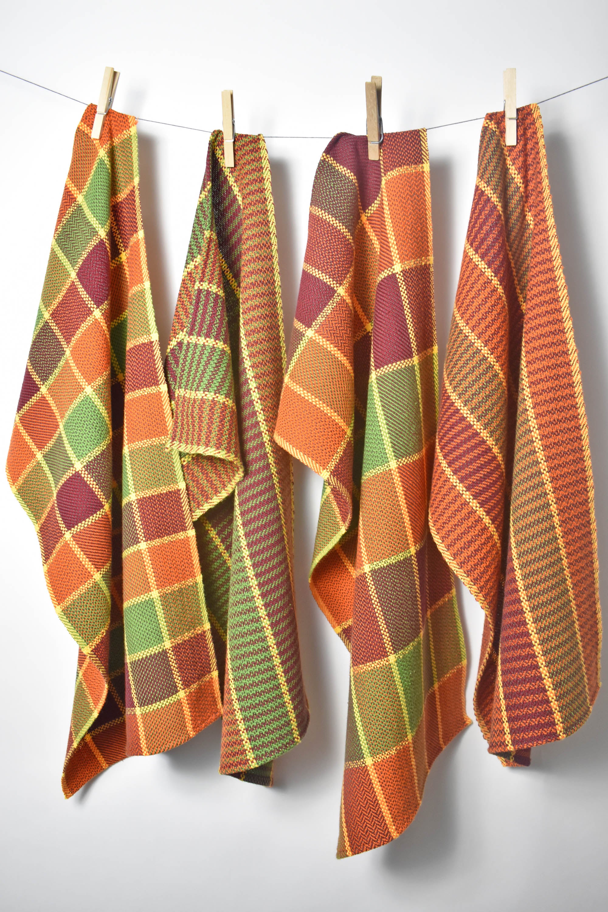 Fall inspired handwoven organic towel hanging on a rope with clothespins