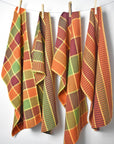 Fall inspired handwoven organic towel hanging on a rope with clothespins