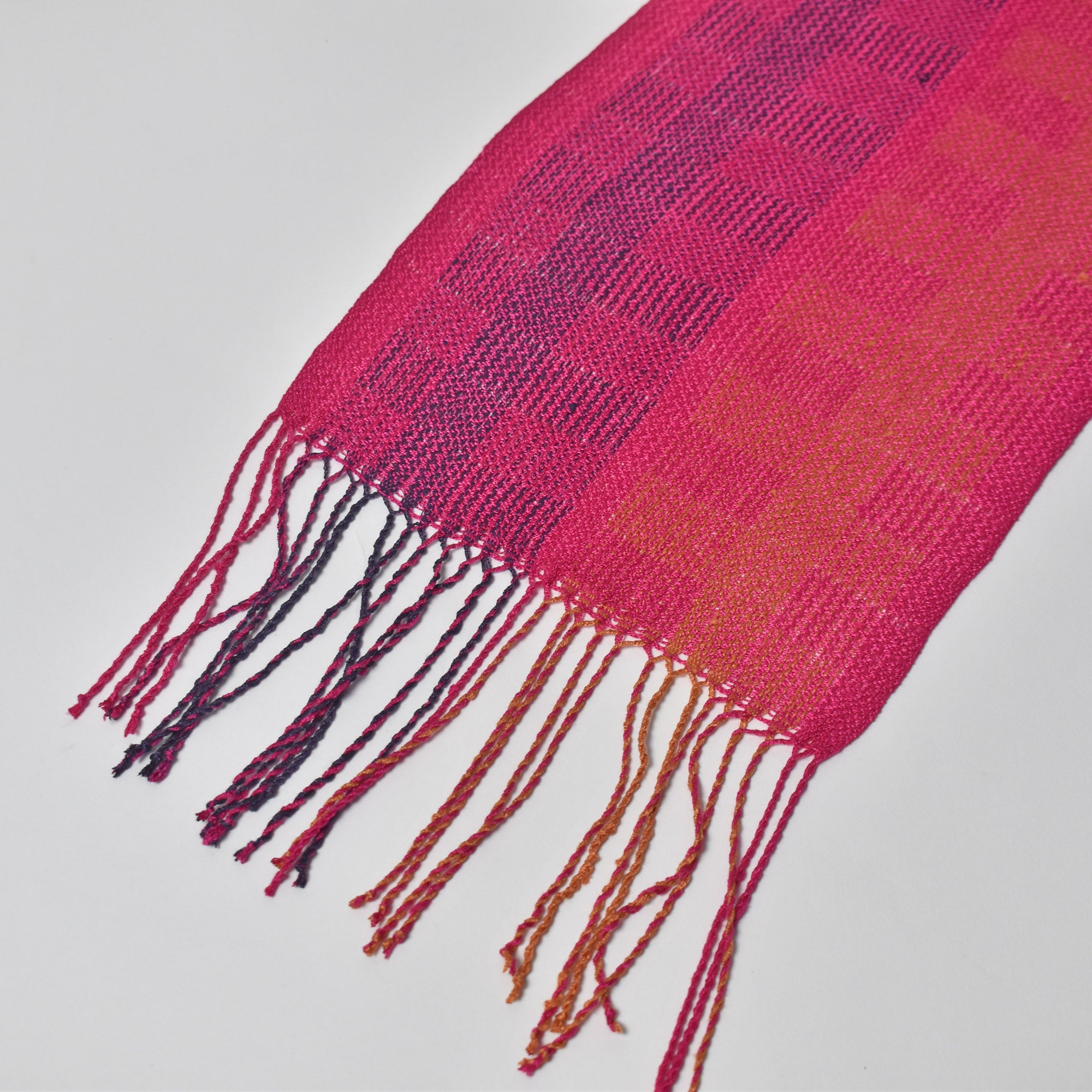 Close-up of the hand twisted fringe on the fuchsia scarf