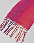 Close-up of the hand twisted fringe on the fuchsia scarf