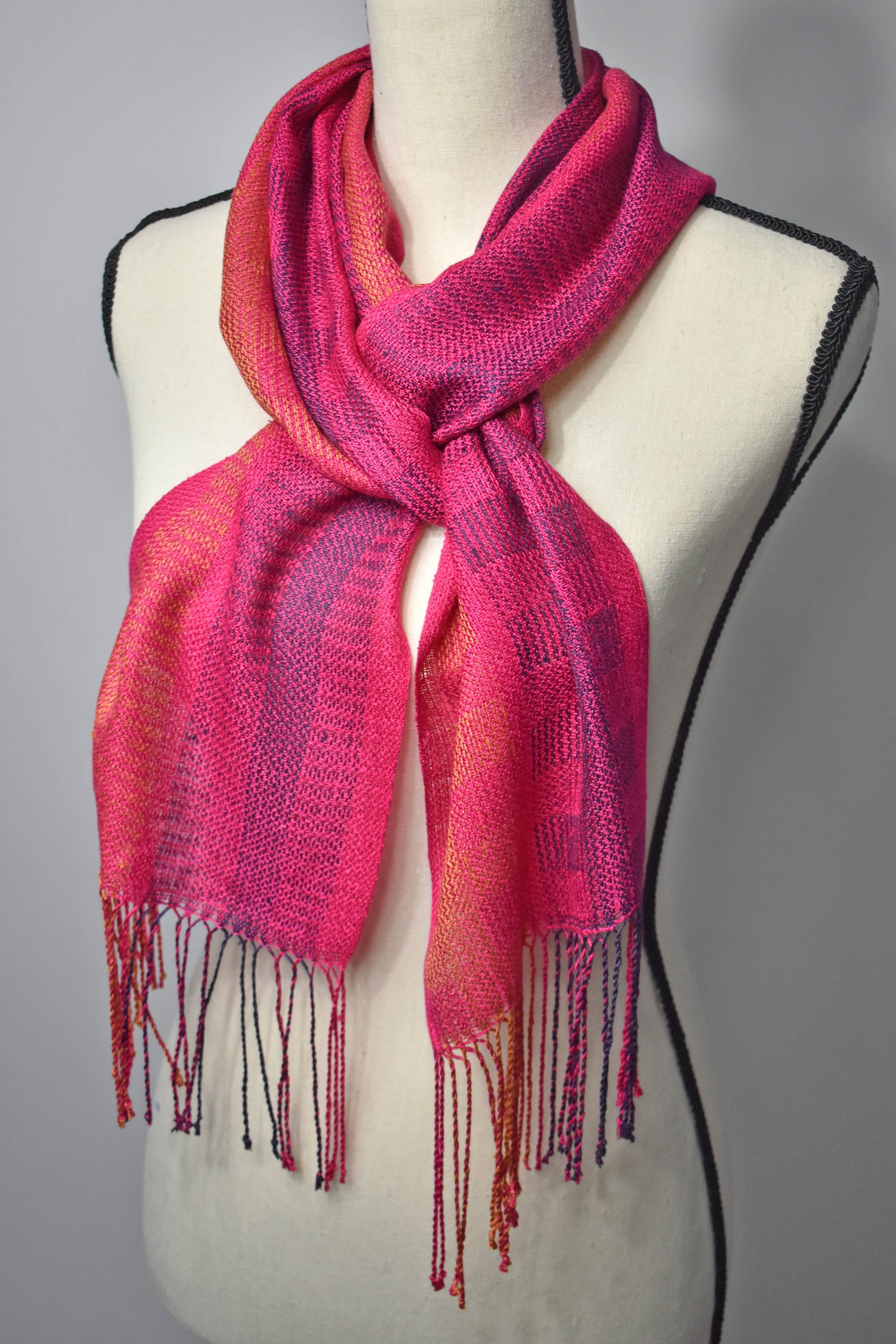 Fuchsia handwoven scarf woven with up-cycled yarns styled on a mannequin