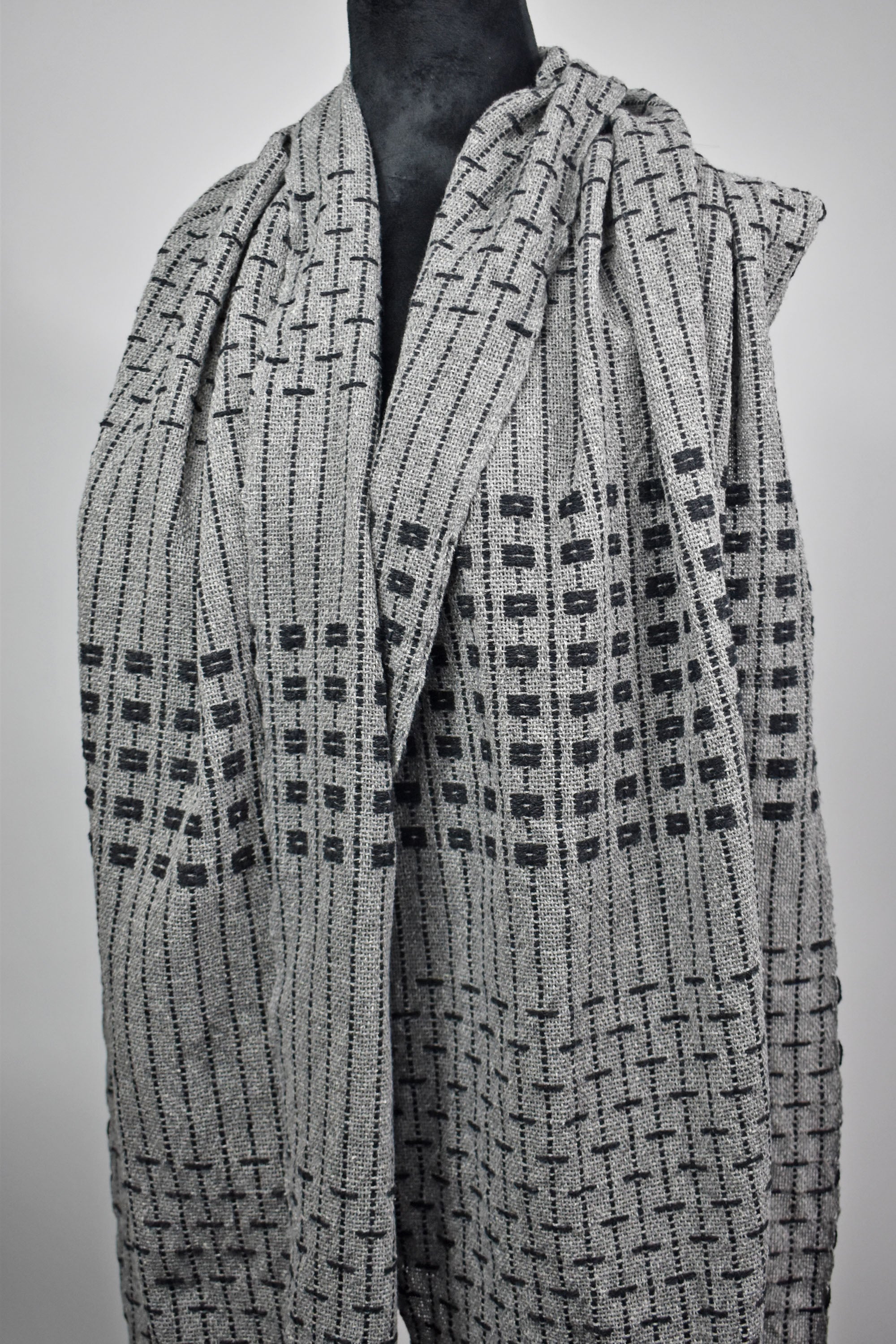 A complete view of the women's handwoven gray shawl.