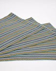 Green striped handwoven organic cotton placemats arranged on a table