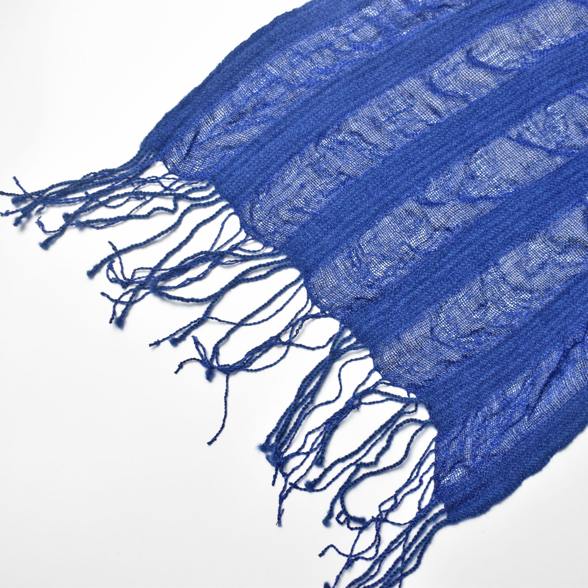 Check the scalloped edges of the hand twisted fringes on this handwoven scarf.