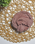 Hydrangea color hand-painted scarf on a white table with a plant and rattan doily