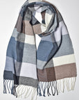 Neutral colored scarf draped on a white table to show the variety of colors