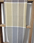 Plaid handwoven cotton tea towel hanging on a wooden ladder