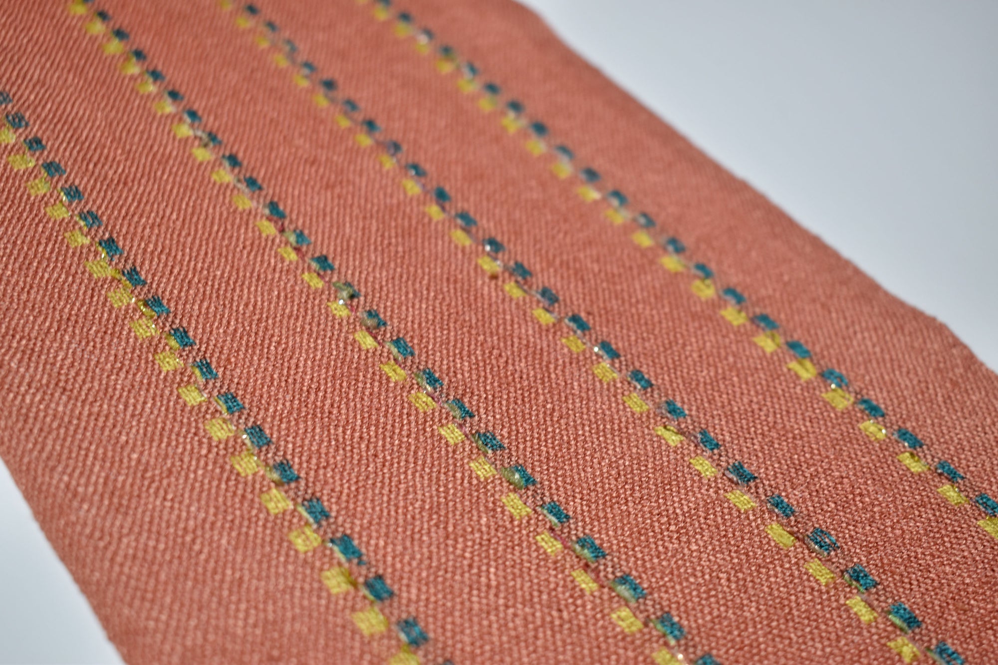 Close-up of the sparkles on the peach handwoven scarf