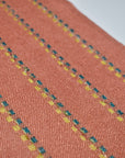 Close-up of the sparkles on the peach handwoven scarf