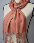 Peach handwoven scarf made with up-cycled exclusive yarns on a mannequin