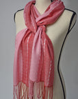 Pink + red handwoven scarf with up-cycled exclusive yarns on a mannequin