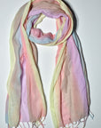 Pastel cotton scarf laying on a white table. 