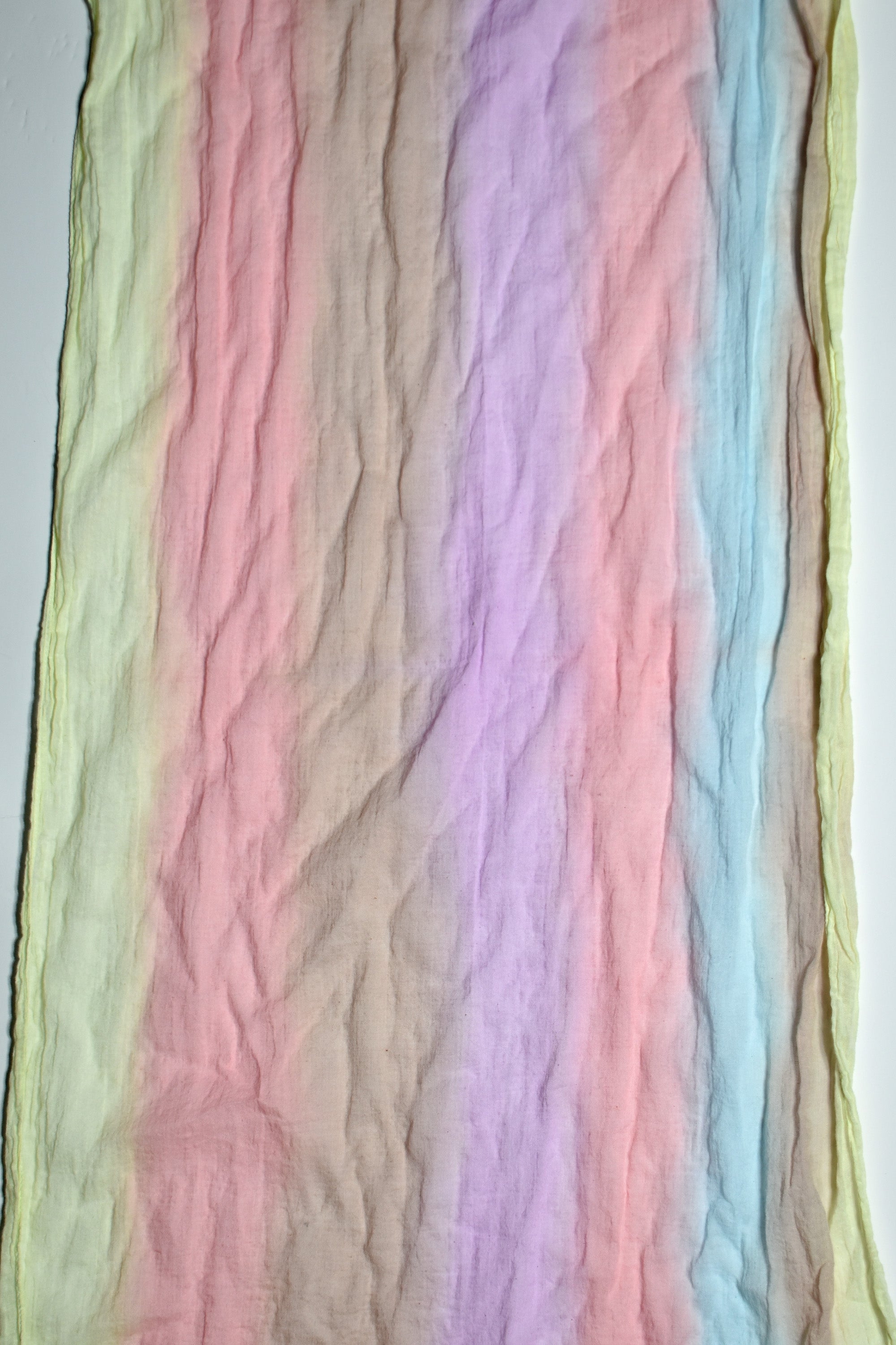 Close-up of the pastel colors of this hand-painted cotton scarf