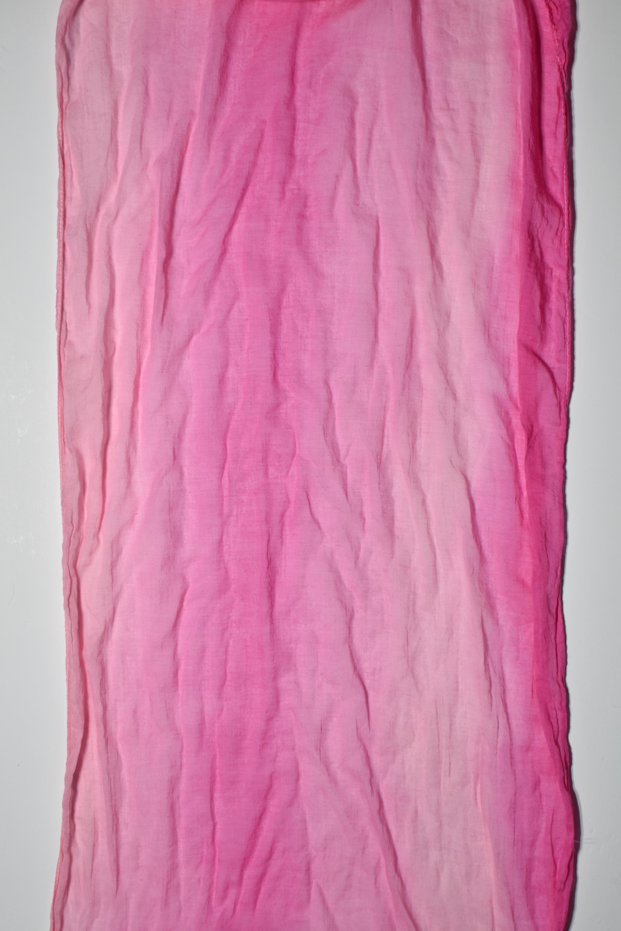 Close-up of the variety of pink colors in this hand-painted cotton scarf that is made in the USA