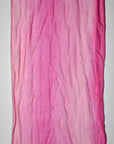 Close-up of the variety of pink colors in this hand-painted cotton scarf that is made in the USA