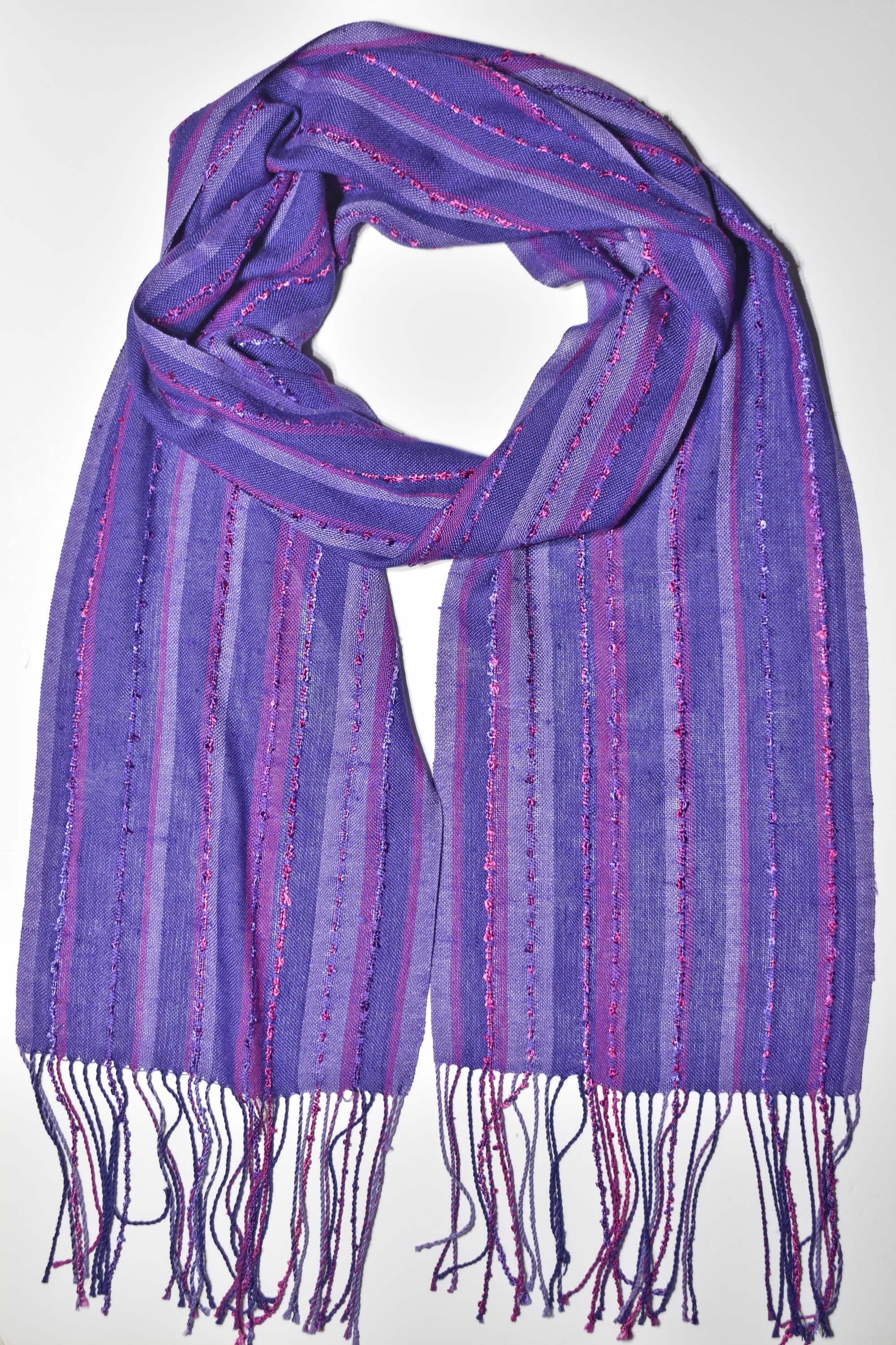 Purple handwoven scarf displayed on a white table