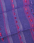 Close-up of handwoven purple scarf folded on a table