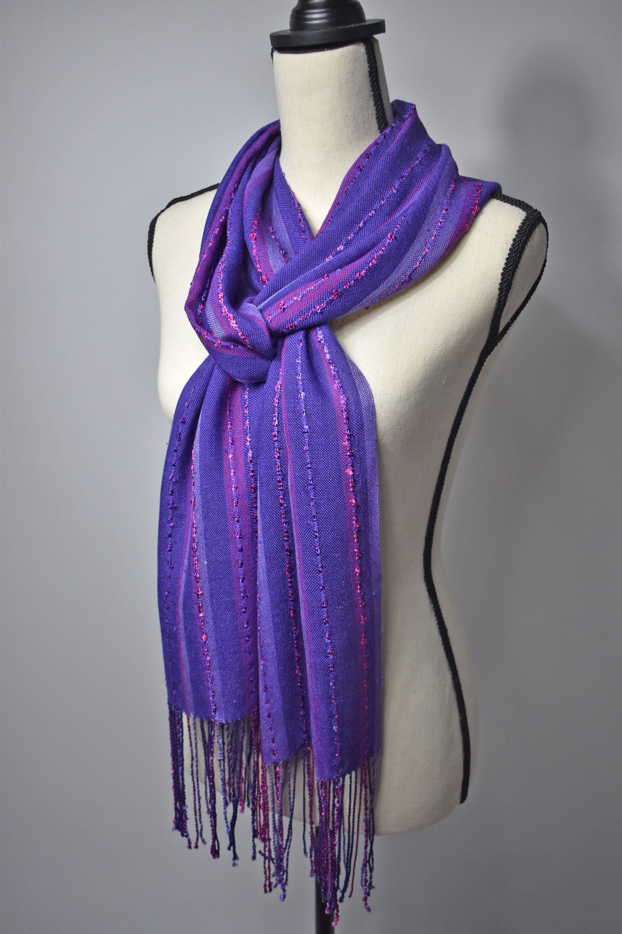 Purple handwoven scarf on a mannequin