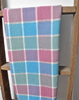 Handwoven plaid cotton towel hanging from a wooden ladder